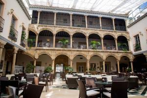 un patio vacío con mesas y sillas en un edificio en Palacio de los Velada, en Ávila