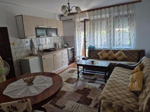 a living room with a couch and a table at Roof - Holiday Home in Gjakove