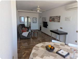 a living room with a couch and a table at Casa Lyngra in Orihuela Costa