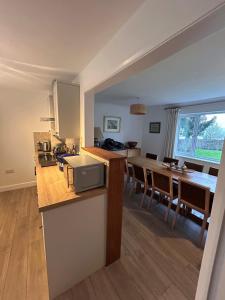 a kitchen and dining room with a table and chairs at The Forge in Avington