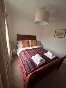 a bedroom with a bed with towels on it at The Forge in Avington
