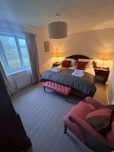 a hotel room with a bed and a couch at The Forge in Avington