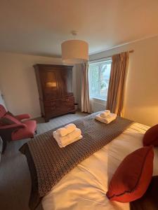 a bedroom with a bed with two towels on it at The Forge in Avington +21 photos