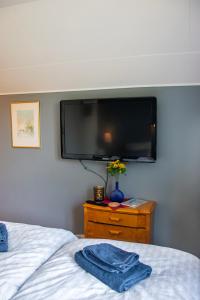 a bedroom with a bed and a tv on a wall at Villa Storfors in Storfors
