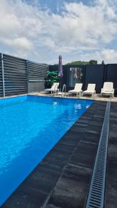 a pool on the roof of a building at Apartmani City ES in Cazin