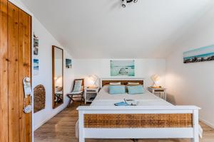 a bedroom with a bed with a white bed frame at Villa Saint Barth in Gujan-Mestras +115 photos