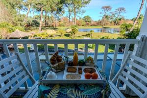 a tray of food on a table on a balcony at Villa Saint Barth in Gujan-Mestras