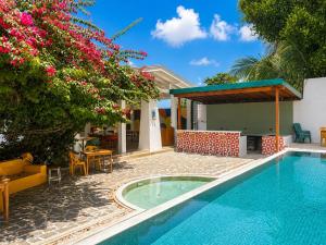 a villa with a swimming pool and a garden at Hebron Gardens House in Kandy