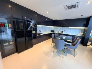 a kitchen with a table and chairs and a counter at LaViena pool villa in Vientiane