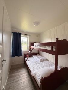 a bedroom with two bunk beds and a window at Saltstraumen camping in Bodø
