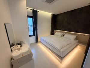 a bedroom with a bed and a large window at LaViena pool villa in Vientiane +44 photos