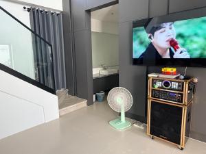 a living room with a tv and a fan at LaViena pool villa in Vientiane