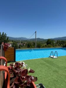 a large swimming pool with a view of a bridge at Kuća za odmor Villa Kovačević in Bihać