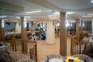 a banquet hall with white tables and blue decorations at Hotel Darina Select in Târgu-Mureş +37 photos
