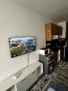 a living room with a tv on the wall at Tsavo in Nairobi