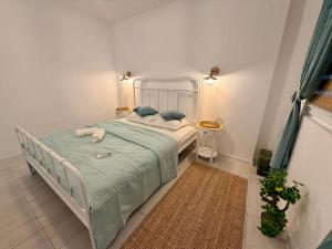 a bedroom with a bed with a green blanket at Casa TEOS in 2 Mai +17 photos