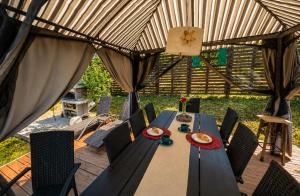a table in a tent with chairs and food on it at Breg&Spa in Beretinec