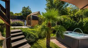 a garden with a bath tub and a palm tree at Breg&Spa in Beretinec +14 photos