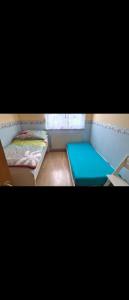 a small room with two beds and a window at Alex & Nicol in Gänserndorf