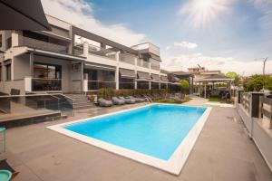 an image of a house with a swimming pool at Amalia Center in Nea Vrasna