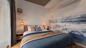 a bedroom with a bed and a painting on the wall at Flatbook Stegna Południowa Apartamenty z Basenem in Stegna