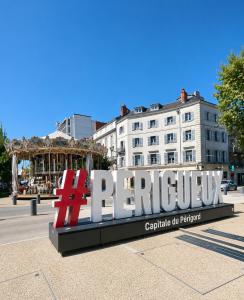 a large sign in a city with a carousel at Studio Boulazac proche Palio in Boulazac