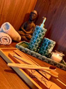a wooden table with chopsticks and a statue of a woman at For-rest Užsienis in Kazitiškis +12 photos