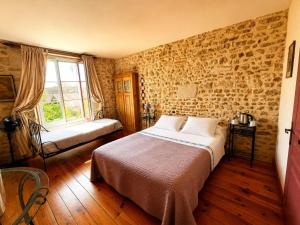 a bedroom with a bed and a window at Aux Caprices des Dieux in Marnes