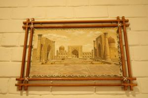 a framed picture of a palace on a wall at Solief Hotel in Tashkent +41 photos