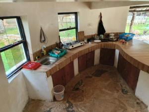 a kitchen with a sink and a counter top at Tiny house, kitchen downstairs in Shimoni