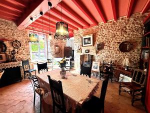 a dining room with a table and chairs at Aux Caprices des Dieux in Marnes