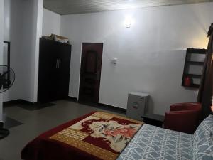 a bedroom with a bed with a blanket on it at Engelbert Beyer Centre in Ibadan