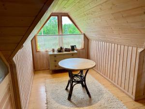 a small table in a room with a window at Countryhome apartment in Jõõpre