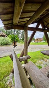 a wooden porch with a potted plant in the background at Countryhome apartment in Jõõpre +3 photos