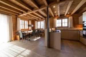 a kitchen and dining room with a table and chairs at Chalet Frümsel - Luxury & Bergblick in Wildhaus