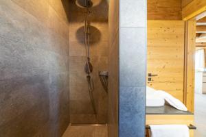 a bathroom with a shower and a sink at Chalet Frümsel - Luxury & Bergblick in Wildhaus +18 photos