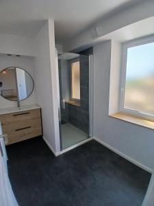 a bathroom with a shower and a sink and a mirror at Chez steph studio in Saint-Germain-Nuelles