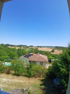 a view of a house with a pool in a field at Chez steph studio in Saint-Germain-Nuelles