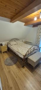 a bed in a room with a wooden ceiling at Leśna Przygoda ,,Balia w cenie" in Harbutowice