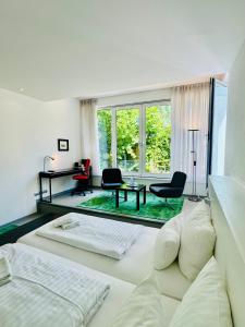 a bedroom with two beds and a living room at Feldberg4you DesignZimmer in Feldberg