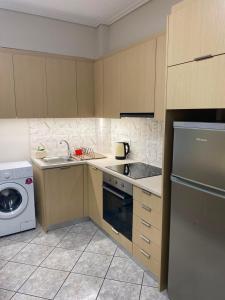 a kitchen with a sink and a dishwasher at Folia City Center with Parking in Chalkida