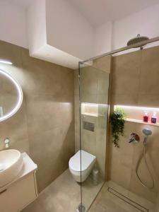 a bathroom with a shower and a toilet and a sink at Folia City Center with Parking in Chalkida