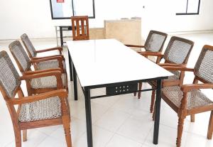 a group of chairs around a table with a white table at Luanda Road View Hotel in Luanda