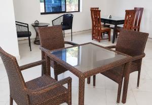 a glass table and chairs in a room at Luanda Road View Hotel in Luanda