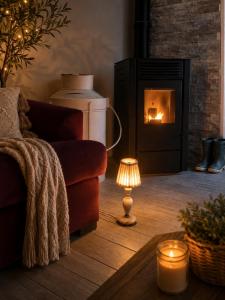 a living room with a couch and a fire place at Le Nid des Wallabys in Monchy-le-Preux