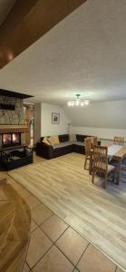 a large living room with a bed and a fireplace at Leśna Przygoda ,,Balia w cenie" in Harbutowice
