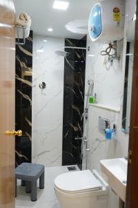 a bathroom with a toilet and a sink at Hotel Maruti in Mandsaur