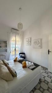 a large white bed with pillows on it in a room at Villa Anna in Quartu SantʼElena