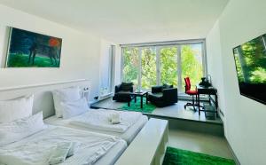 a bedroom with two beds and a living room at Feldberg4you DesignZimmer in Feldberg +13 photos