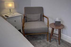 a bedroom with a chair and a table and a bed at Best Western Stoke on Trent City Centre Hotel in Stoke on Trent